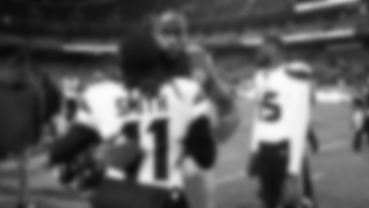 Kansas City Chiefs defensive end Charles Omenihu (90) hugs Houston Texans cornerback Tremon Smith (11) after an NFL week 14 matchup against the Houston Texans, Sunday December 7, 2025.