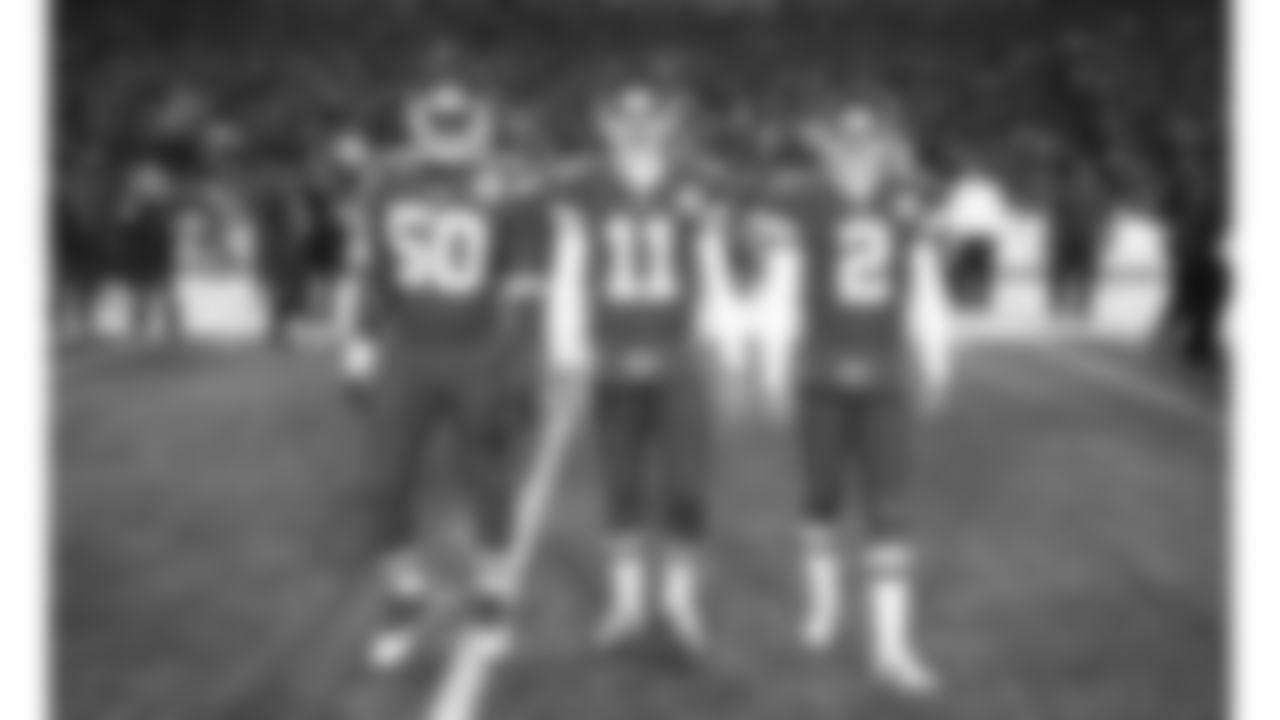 Kansas City Chiefs linebacker Justin Houston (50), quarterback Alex Smith (11) and punter Dustin Colquitt (2) walk out as captains for the Nov. 30, 2014 home game against the Denver Broncos.