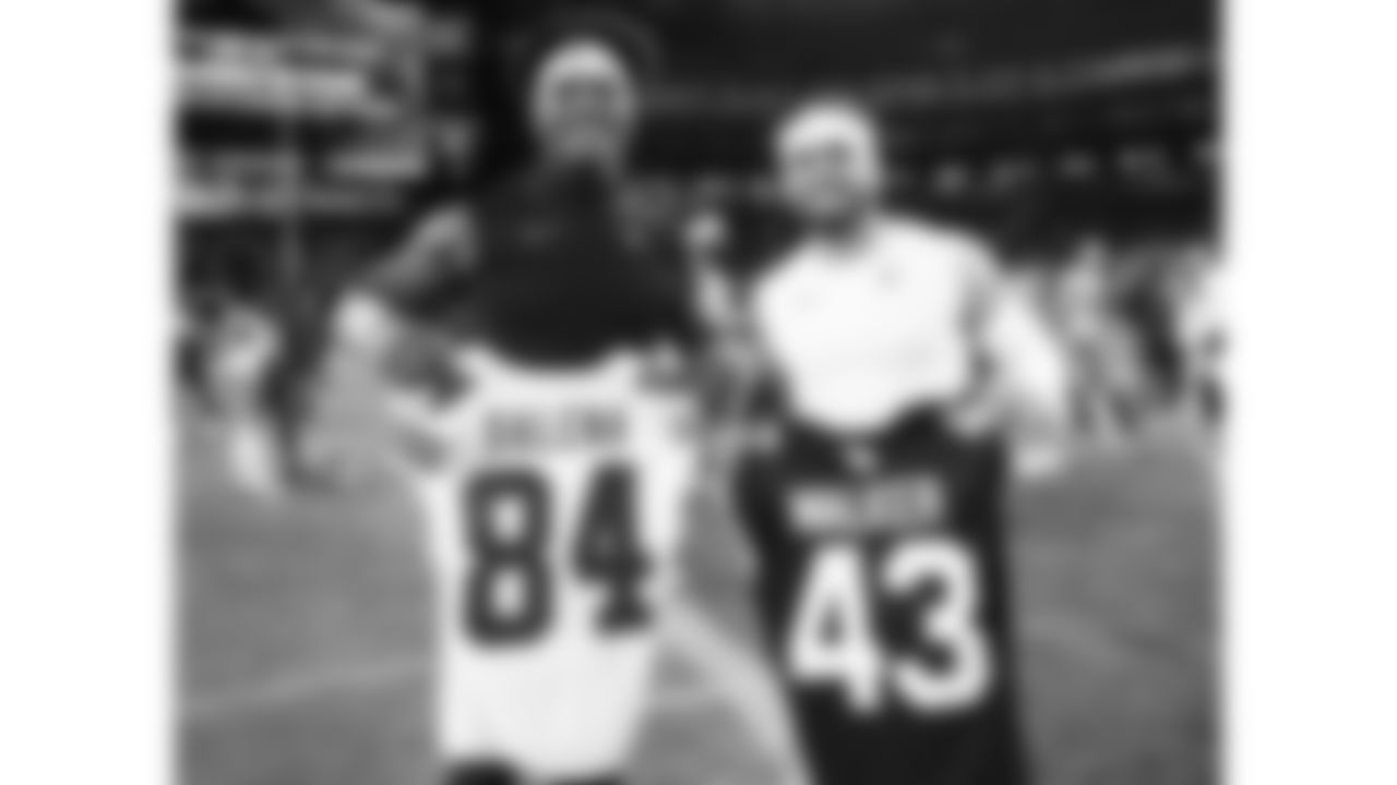 Kansas City Chiefs wide receiver Mac Dalena (84) and Arizona Cardinals linebacker Mykal Walker (43) following a preseason week 1 NFL football game, Saturday, August 9, 2025 in Glendale, AZ.