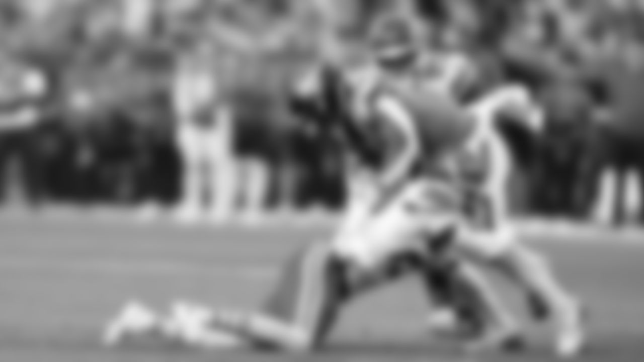 Kansas City Chiefs defensive back Chamarri Conner (27) and middle linebacker Drue Tranquill (23) make a tackle during a week 11 NFL Football game against the Denver Broncos on Sunday, November 16, 2025 in Denver, Colorado.