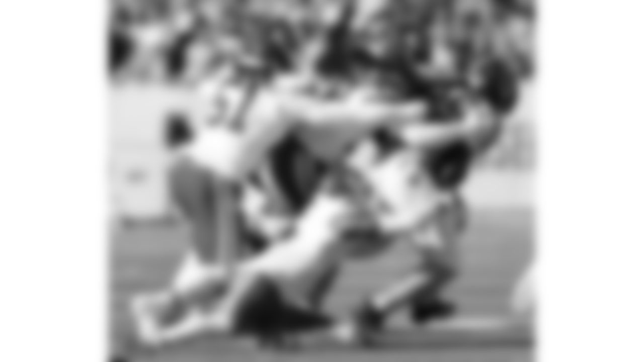 Kansas City Chiefs defensive end Mike Danna (51), linebacker Nick Bolton (32), and safety Bryan Cook (6) make a tackle during a week 16 NFL Football game against the Tennessee Titans on Sunday, December 21, 2025 in Nashville, Tennessee.