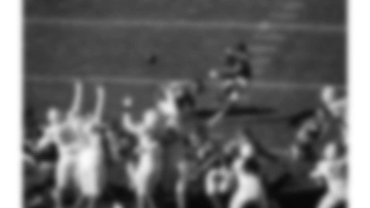 Kansas City Chiefs punter Matt Araiza (14) holds the ball while kicker Harrison Butker (7) kicks a field goal during a week 15 NFL football game against the Los Angeles Chargers, Sunday, December 14, 2025 in Kansas City, MO.