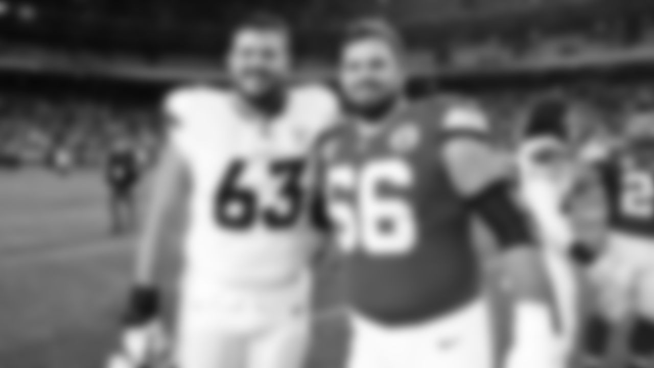 Kansas City Chiefs defensive end George Karlaftis (56) stands with Denver Broncos tackle Alex Palczewski (63) after an NFL week 17 matchup against the Denver Broncos, Thursday, December 25, 2025.