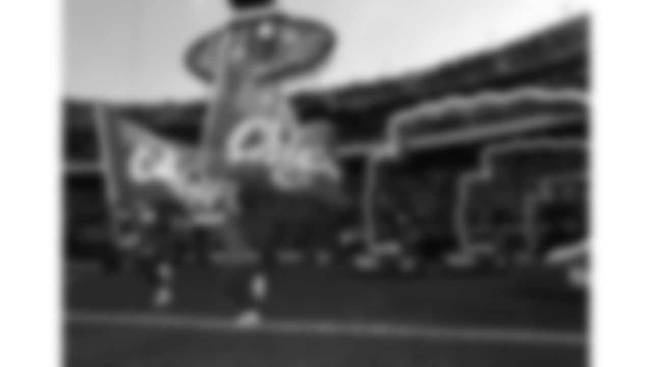 Chiefs flag runners enter the field prior to a week 15 NFL Football game against the Los Angeles Chargers on Sunday, December 14, 2025 in Kansas City, MO.