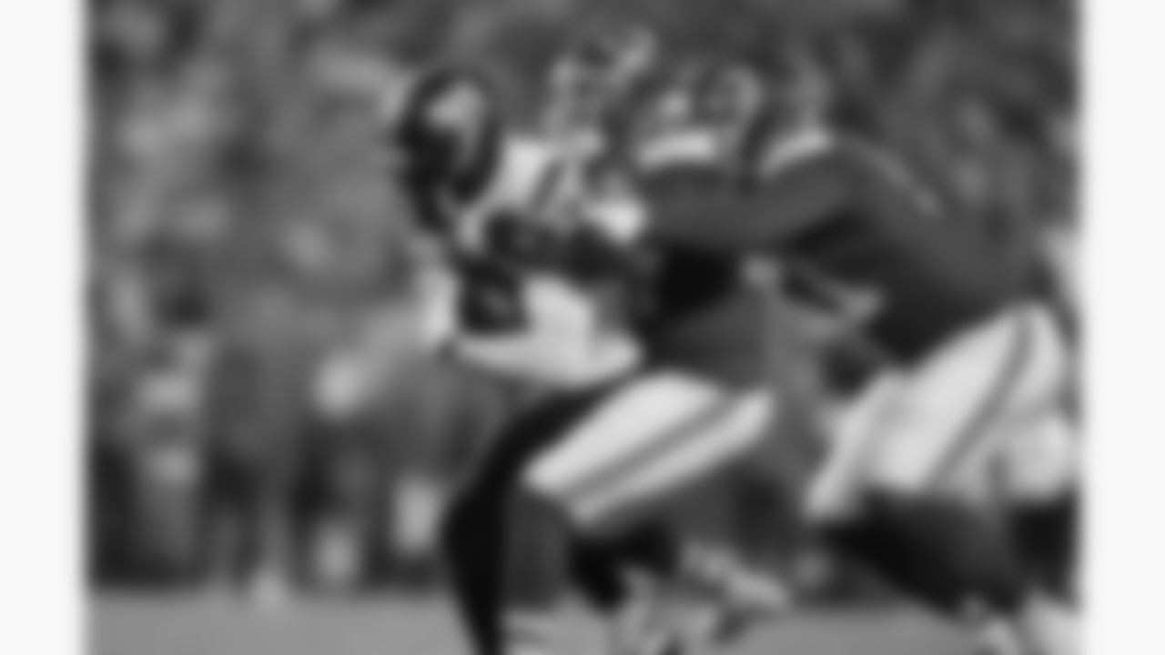 Kansas City Chiefs defensive back Chamarri Conner (27) and defensive end Mike Danna (51) tackle a Washington receiver during a week 8 NFL Football game against the Washington Commanders on Monday, October 27, 2025 in Kansas City, MO.