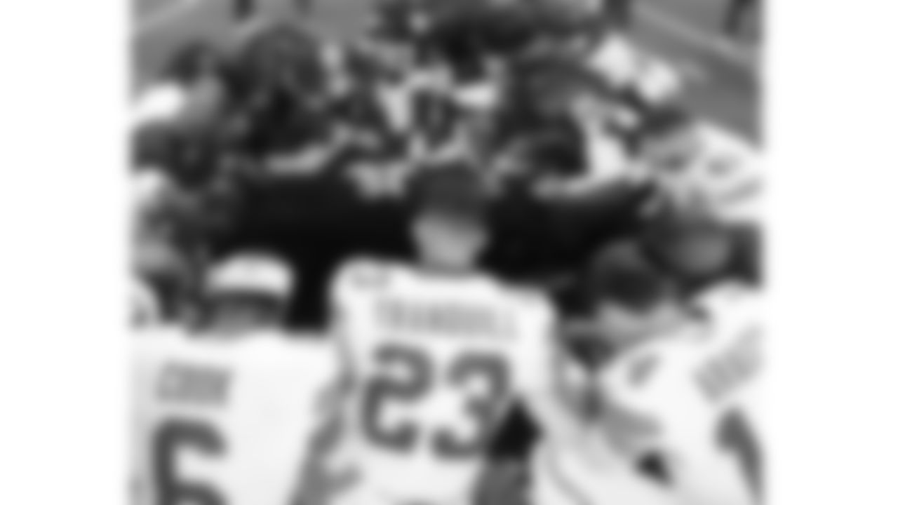 Punter Matt Araiza (14), linebacker Drue Tranquill (23), safety James Cook (6) and long snapper James Winchester (41) pray on the field after a week 13 NFL Football game against the Dallas Cowboys on Thursday, November 27, 2025 in Dallas, Texas.