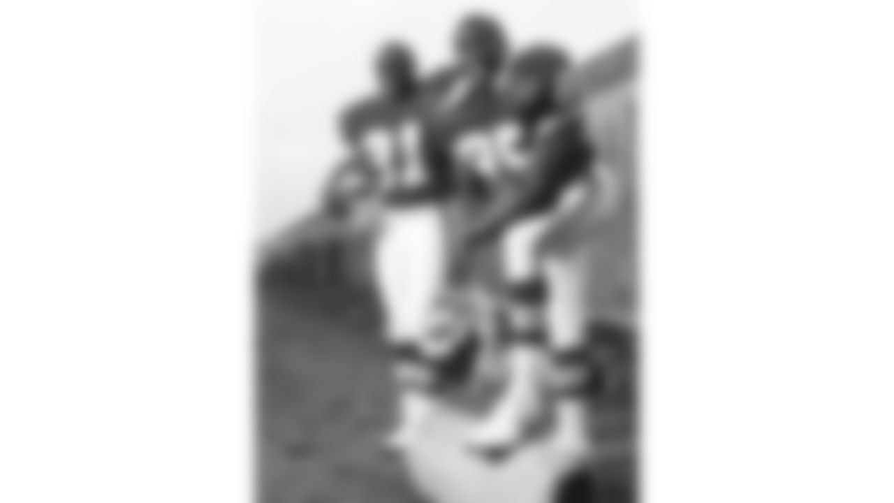 Kansas City Chiefs running back James Saxon (21) and tight end Johnathan Hayes (85) pose at the Berlin Wall in 1990.