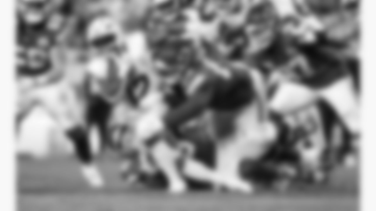 Kansas City Chiefs defensive end George Karlaftis (56) and nose tackle Mike Pennel (69) tackle Denver Broncos running back RJ Harvey (12) during a week 17 NFL football game, Thursday, December 25, 2025 in Kansas City, MO.