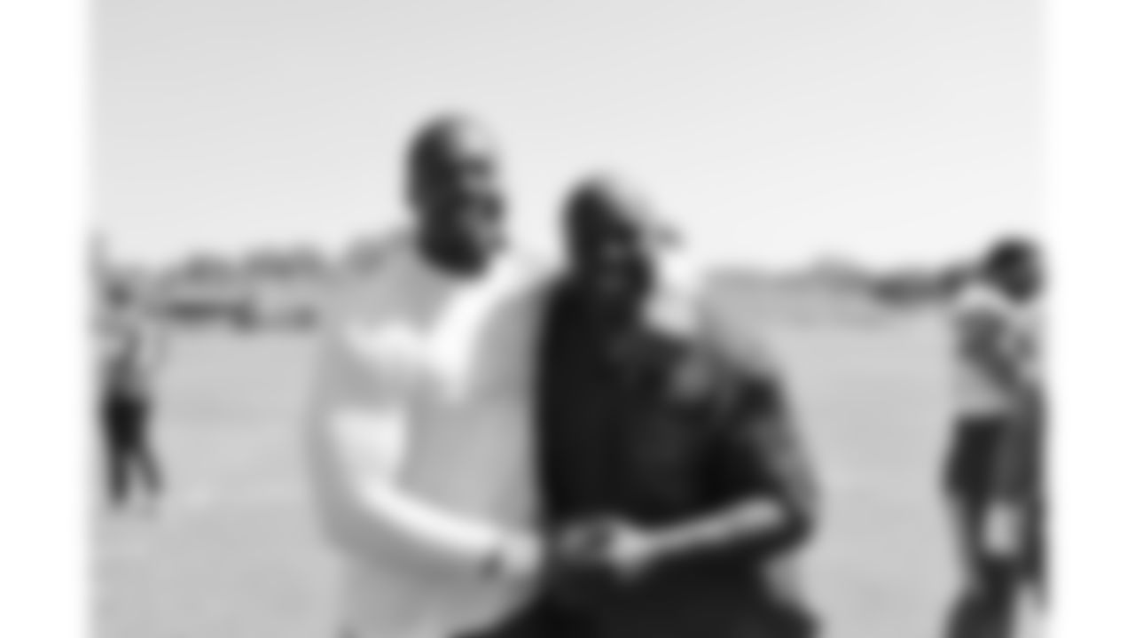 Former Chiefs players Tamba Hali from the Kansas City Ambassadors and Legends group with defensive tackle Chris Jones (95) after day 6 of training camp practice on Monday, July 28, 2025.