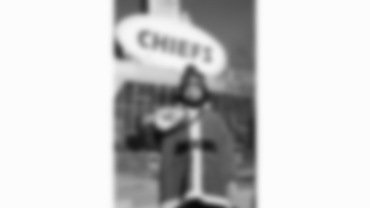 A young Kansas City Chiefs fan dressed as Santa poses outside GEHA Field at Arrowhead Stadium prior to a week 15 NFL football game against the Los Angeles Chargers, Sunday, December 14, 2025 in Kansas City, MO.