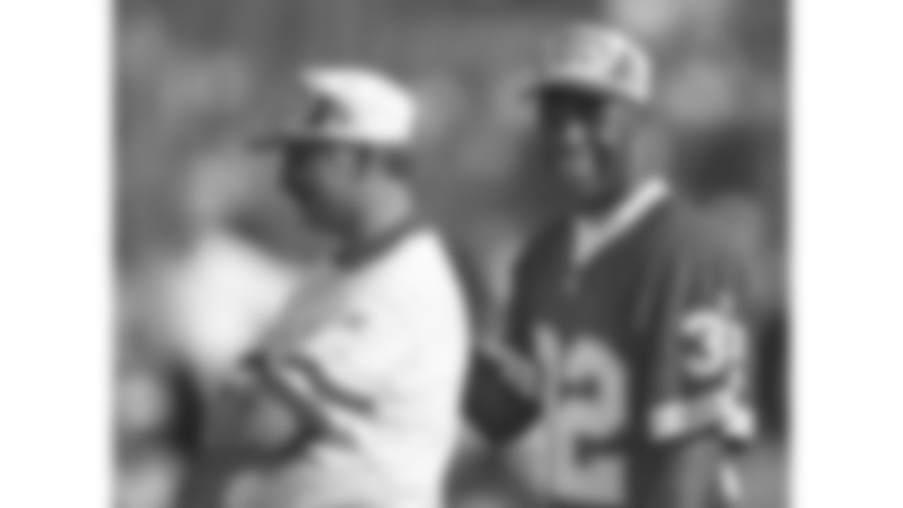Kansas City Chiefs running back Marcus Allen (32) stands on the sideline with head trainer Dave Kendall during the 1996 preseason trip to Monterrey, Mexico.