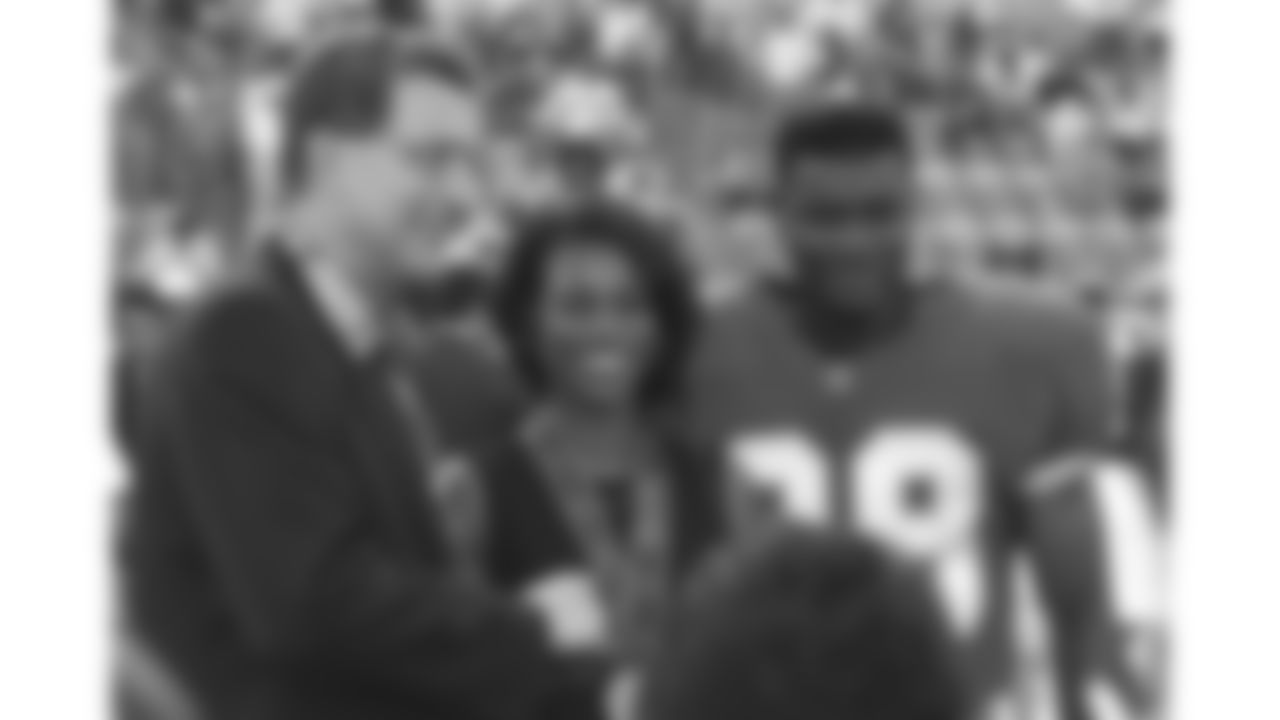 NFL commissioner Paul Tagliabue shakes hands with an olympian and her husband, a Kansas City Chiefs player, during the 1996 preseason trip to Monterrey, Mexico.