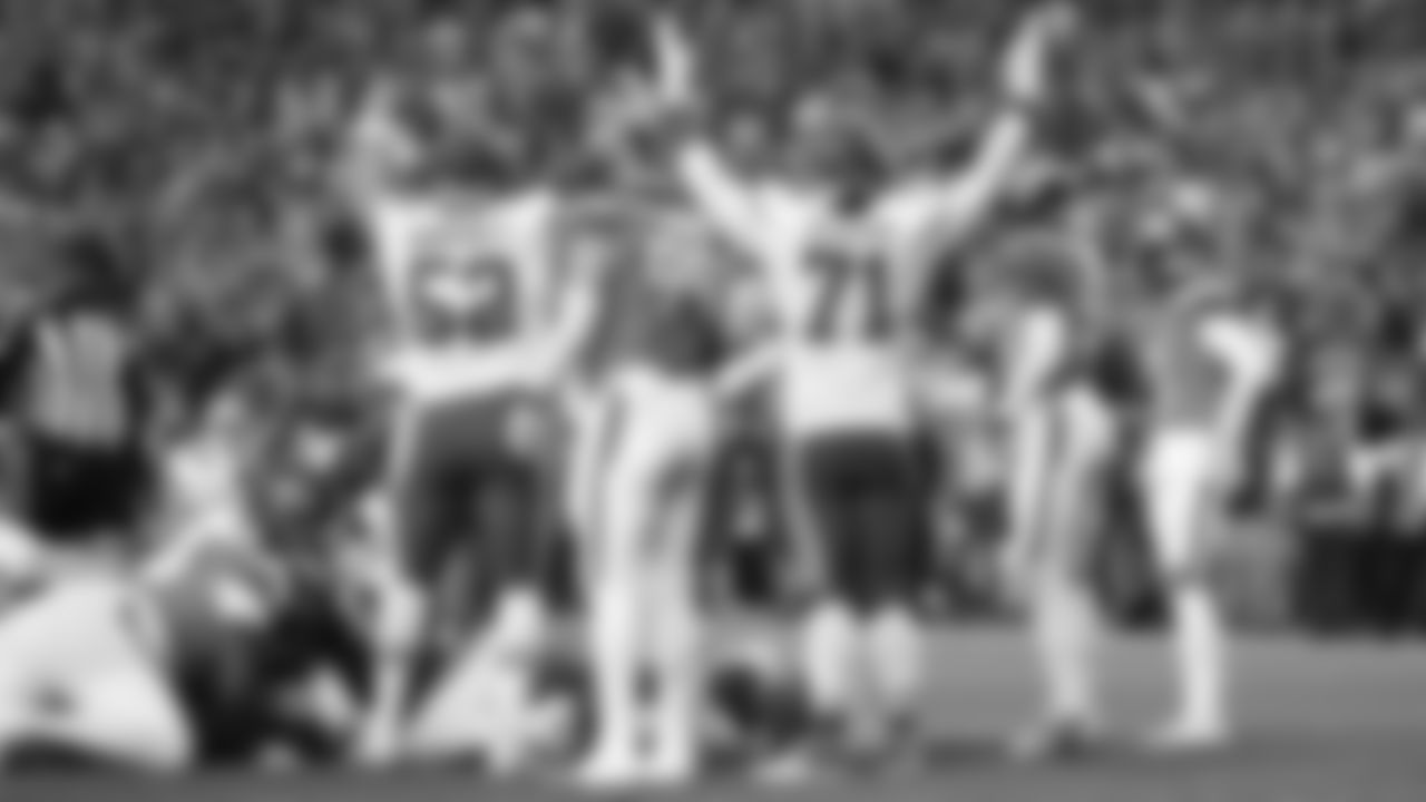 Kansas City Chiefs center Creed Humphrey (52) and tackle Josh Simmons (71) hold up their arms after a touchdown during a week 11 NFL Football game against the Denver Broncos on Sunday, November 16, 2025 in Denver, Colorado.