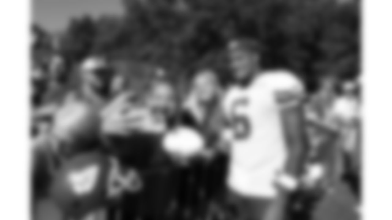 Kansas City Chiefs safety Bryan Cook (6) poses with fans after day 17 of Training Camp practice on Wednesday, August 13, 2025.