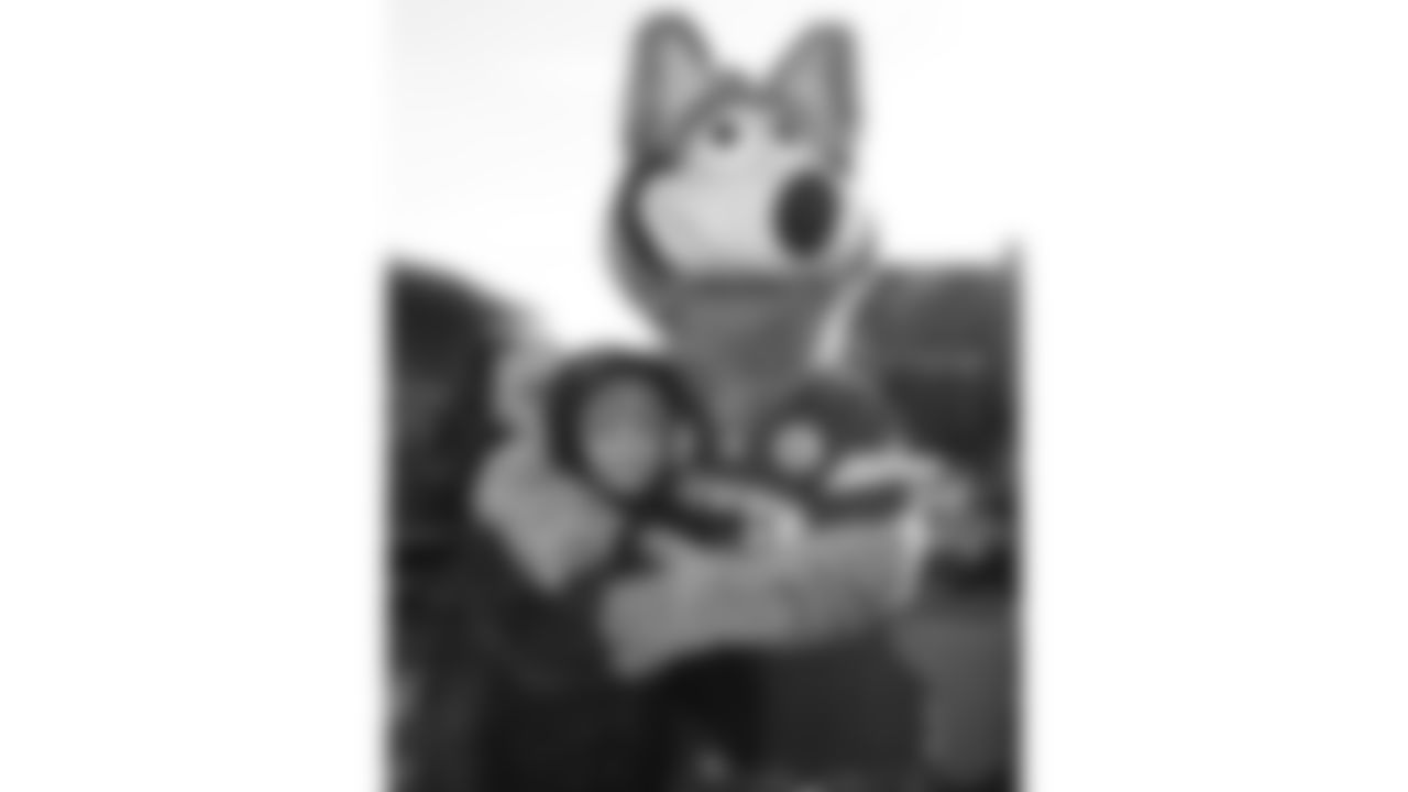 KC Wolf poses with fans in the Ford Tailgate District prior to a week 15 NFL Football game against the Los Angeles Chargers on Sunday, December 14, 2025 in Kansas City, MO.