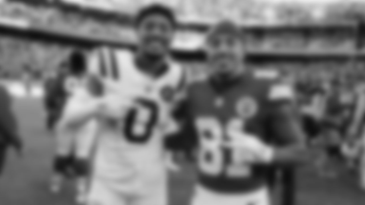 Kansas City Chiefs wide receiver Nikko Remigio (81) poses with Indianapolis Colts safety Camryn Bynum (0) after a week 12 NFL Football game against the Indianapolis Colts on Sunday, November 23, 2025 in Kansas City, MO