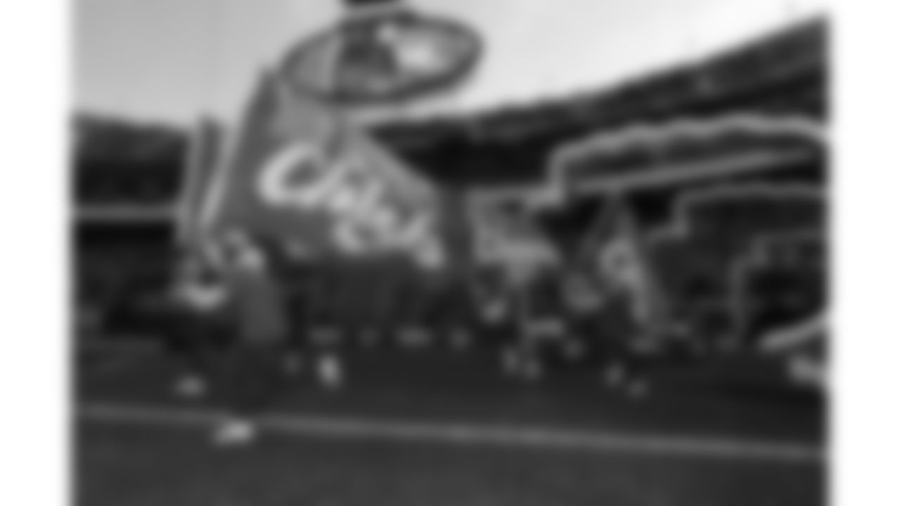 Chiefs Flag Runners enter the field prior to a week 15 NFL Football game against the Los Angeles Chargers on Sunday, December 14, 2025 in Kansas City, MO.