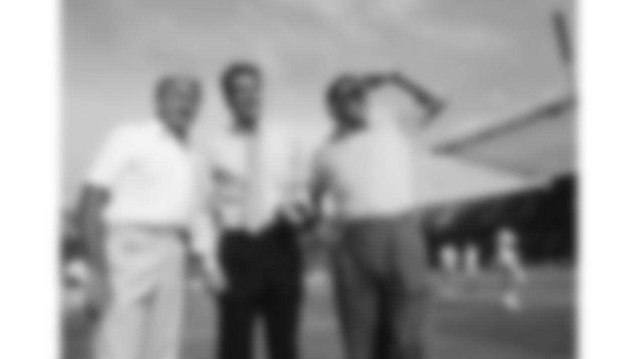 Bill Grigsby, Kevin Harlan and Len Dawson stand on the field in Berlin, Germany before a 1990 preseason game agains the Los Angeles Rams.