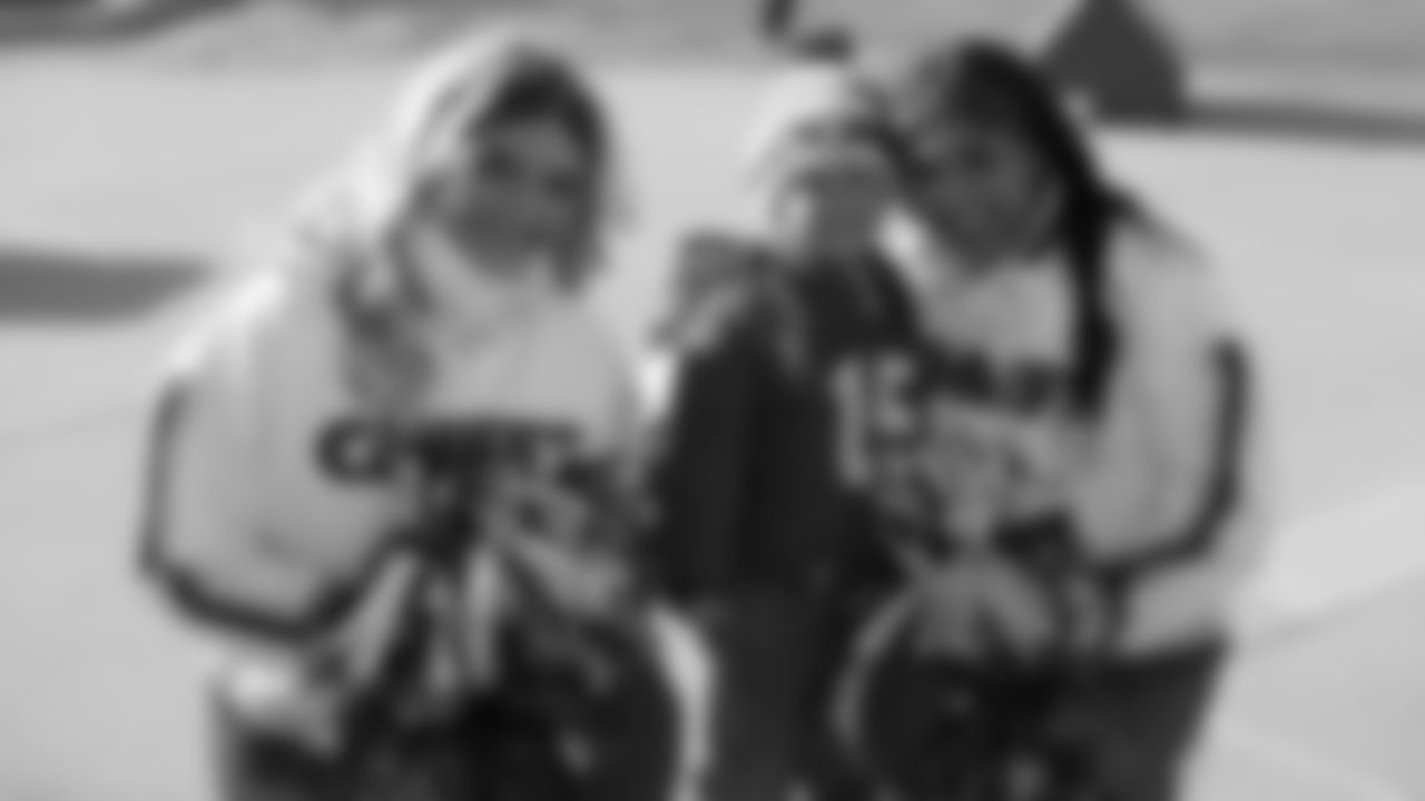 Kansas City Chiefs Cheerleaders with a young fan prior to a week 15 NFL Football game against the Los Angeles Chargers on Sunday, December 14, 2025 in Kansas City, MO.