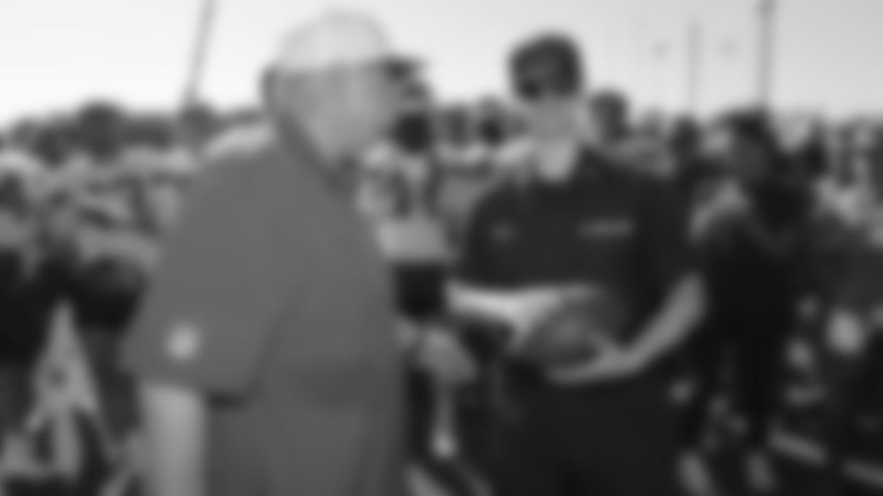 U.S. service members receives a ball from Kansas City Chiefs Head Coach Andy Reid while attending Military Appreciation Day during day 17 of Training Camp practice on Wednesday, August 13, 2025.