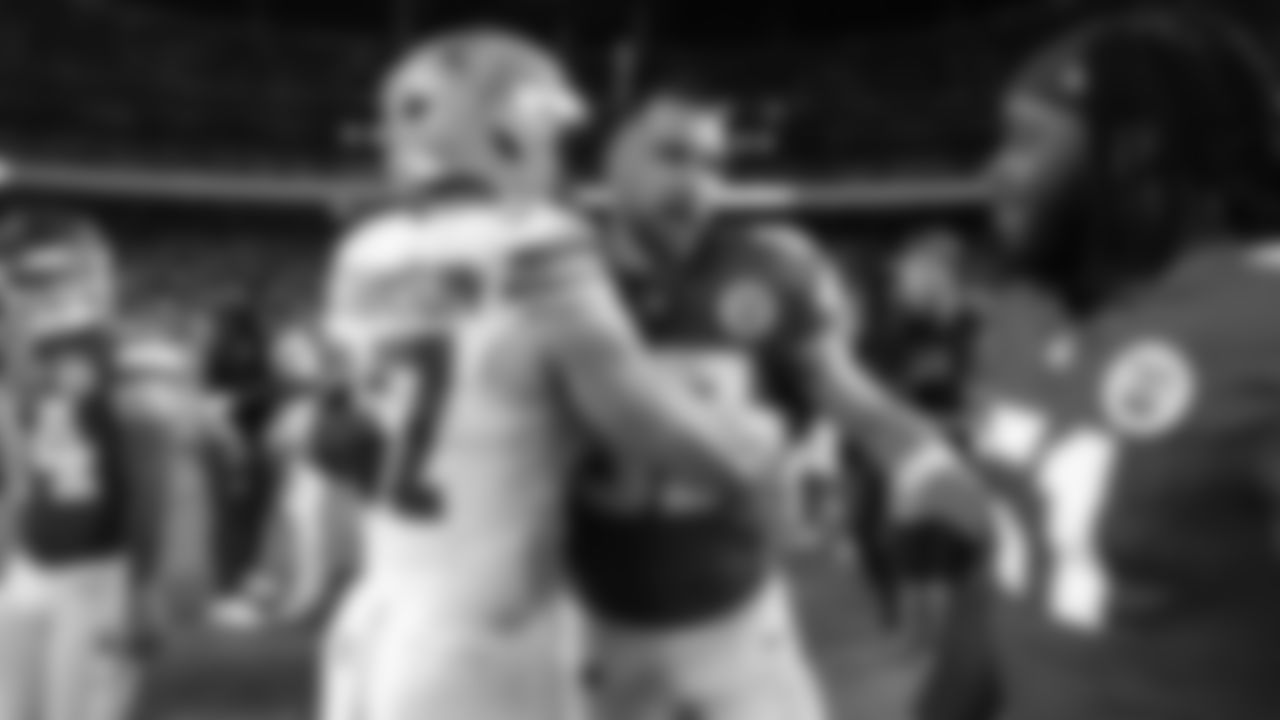 Kansas City Chiefs tight end Travis Kelce (87) hugs Detroit Lions defensive edge Aidan Hutchinson (97) after a week 6 NFL Football game against the Detroit Lions on Sunday, October 12, 2025 in Kansas City, MO.