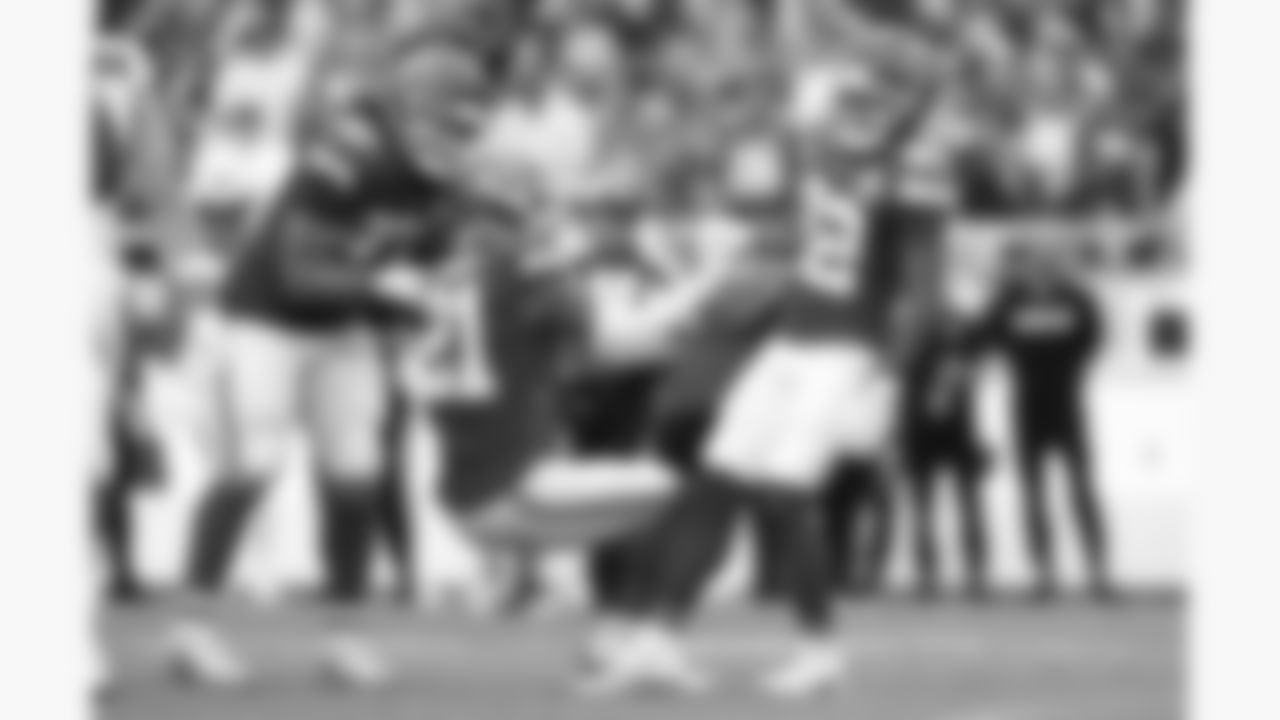 Kansas City Chiefs cornerback Trent McDuffie (22) and defensive end Ashton Gillotte (97) help defensive back Jaden Hicks (21) up during the week 2 NFL football game against the Philadelphia Eagles, Sunday, September 14, 2025 in Kansas City, MO.