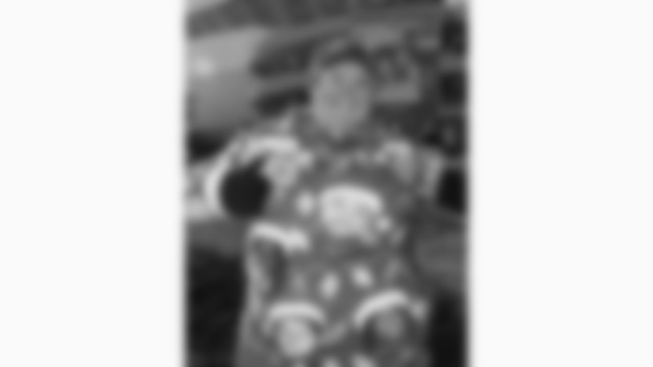 A Kansas City Chiefs fan wears a sweater with players' faces printed prior to a week 15 NFL football game against the Los Angeles Chargers, Sunday, December 14, 2025 in Kansas City, MO.