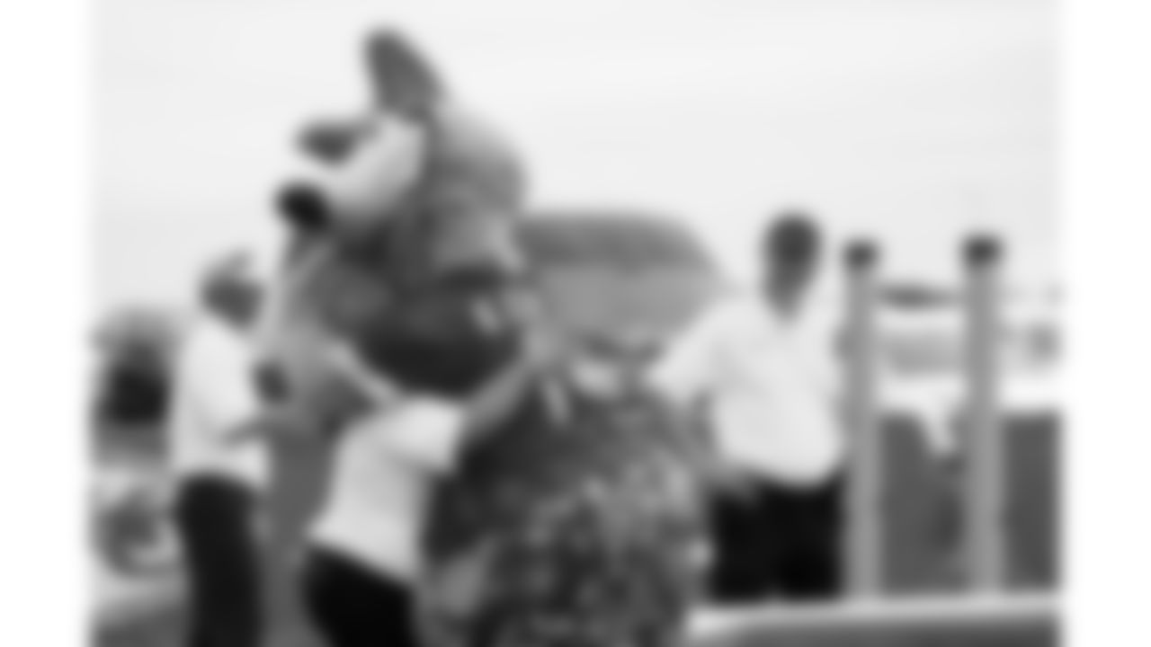 KC Wolf hugs security staff during day 1 of the Season Ticket Member First Look Event on Tuesday June 17, 2025 in Kansas City, MO.