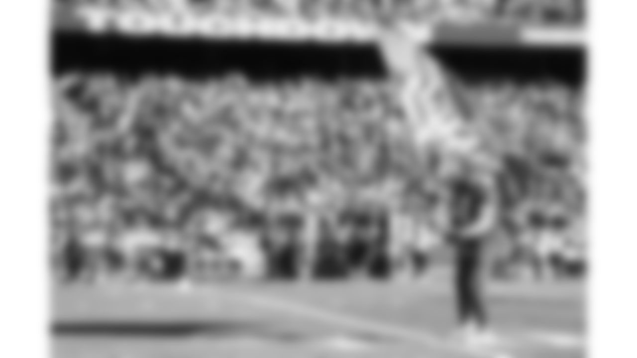 Chiefs Flag Runners wave during a week 15 NFL Football game against the Los Angeles Chargers on Sunday, December 14, 2025 in Kansas City, MO.