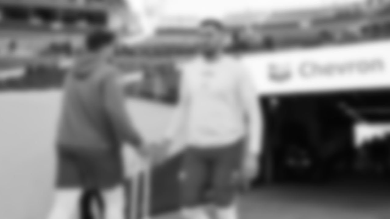 Kansas City Chiefs long snapper James Winchester (41) high fives Kansas City Chiefs offensive lineman Michael Caliendo (66) prior to a week 11 NFL Football game against the Denver Broncos on Sunday, November 16, 2025 in Denver, Colorado.