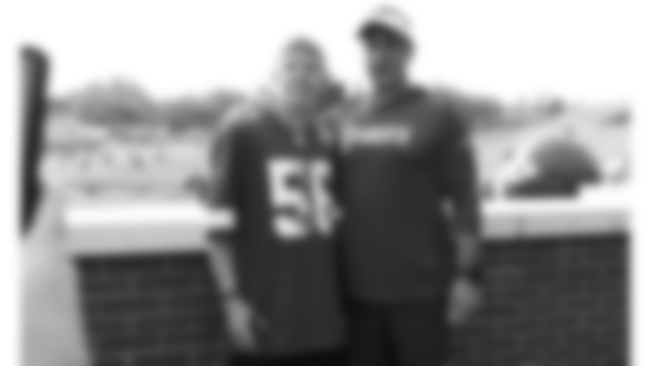 Kansas City Chiefs General Manager Brett Veach and a fan during The Season Ticket Member Pancake Breakfast before day 14 of training camp on Thursday, August 7, 2025.