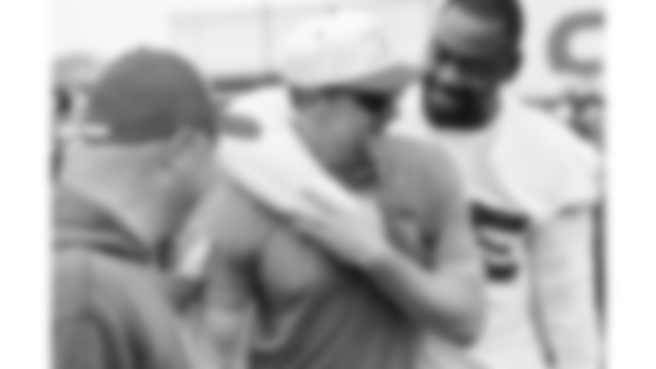 Kansas City Chiefs defensive tackle Chris Jones (95) hugs former punter Dustin Colquitt while attending a practice during phase 3 of OTAs on Wednesday, June 4, 2025 in Kansas City, MO.