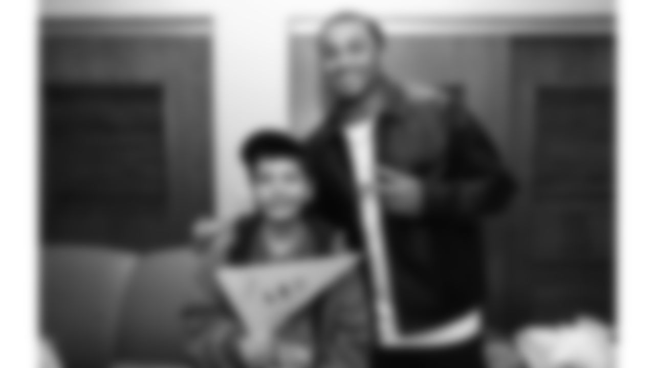 Kansas City Chiefs cornerback Trent McDuffies (22) with a fan before his My Cause My Cleats reveal at the Solace House in Shawnee Mission, Kansas on Tuesday, November 11, 2025.