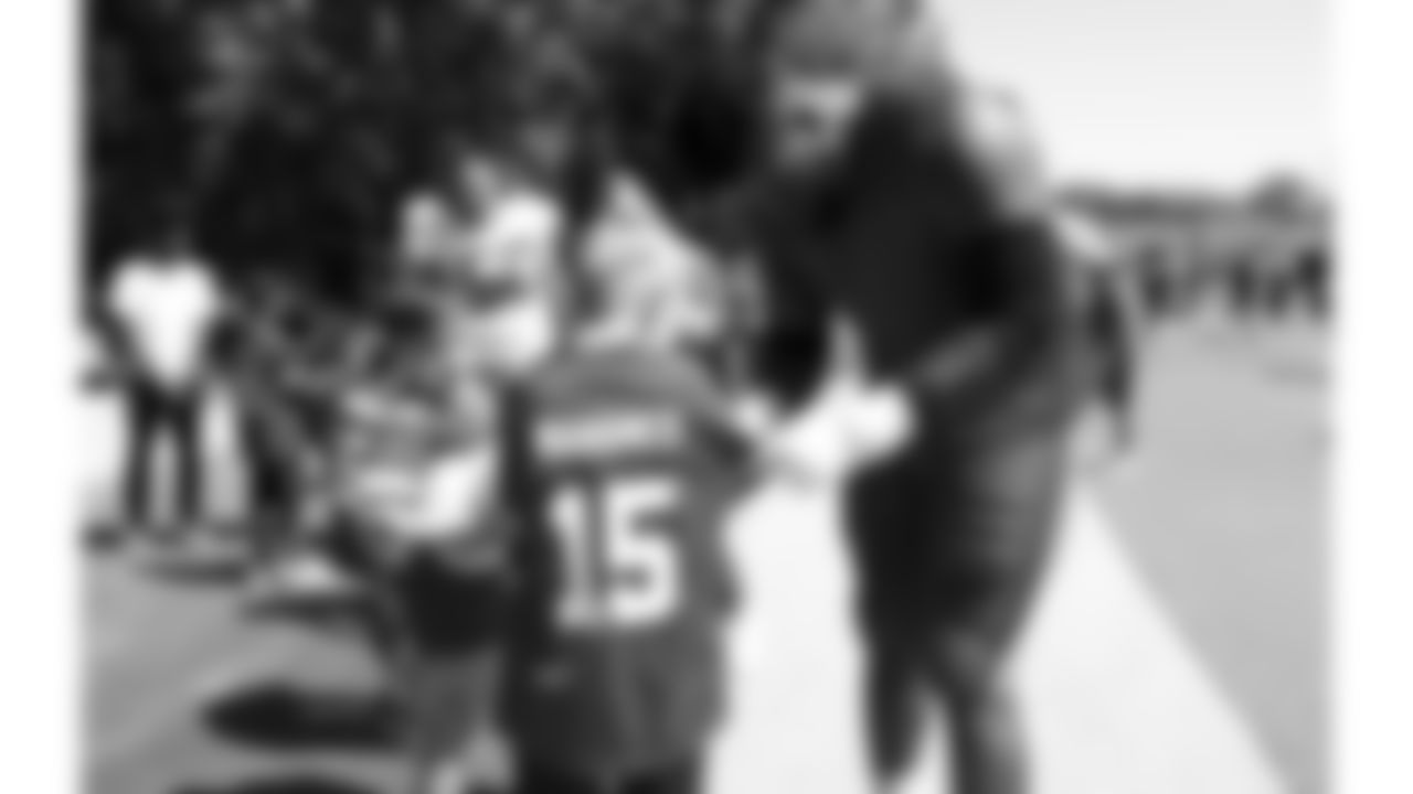 Kansas City Chiefs offensive lineman Trey Smith (65) with Make A Wish and dream factory kids during day 7 of training camp on Tuesday, July 29, 2025.