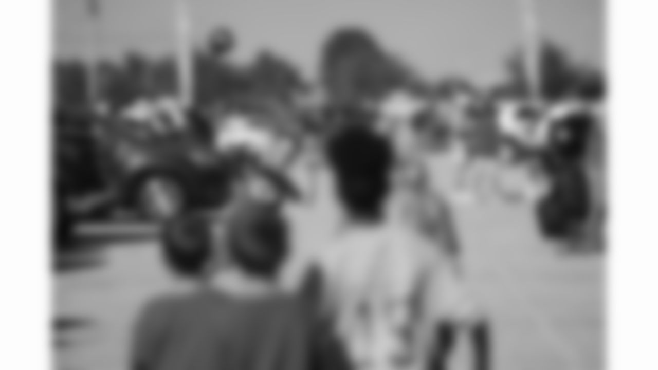 Kansas City Chiefs fan throws a football in the parking lot at GEHA Field at Arrowhead Stadium prior to a preseason week 3 NFL football game against the Chicago Bears, Friday, August 22, 2025 in Kansas City, MO.