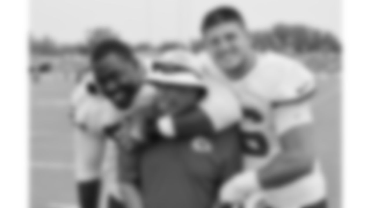 Kansas City Chiefs defensive tackle Chris Jones (95) and defensive end George Karlaftis (56) pose with Vice President of Sports Medicine and Performance Rick Burkholder during day 11 of training camp practice on Sunday, August 3, 2025.