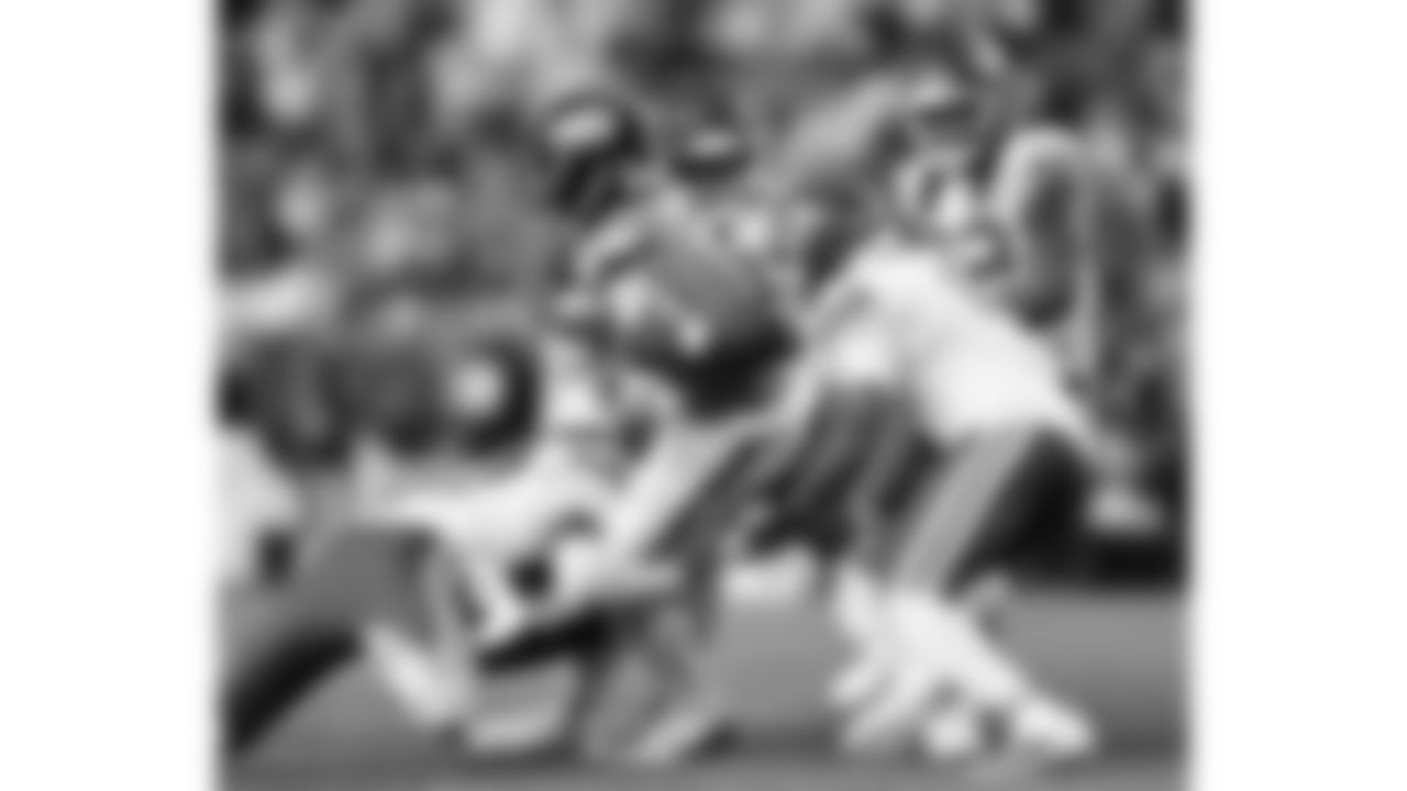 Kansas City Chiefs cornerback Joshua Williams (2), defensive end Mike Danna (51) and safety Bryan Cook (6) tackle a Broncos ball carrier during a week 11 NFL Football game against the Denver Broncos on Sunday, November 16, 2025 in Denver, Colorado.