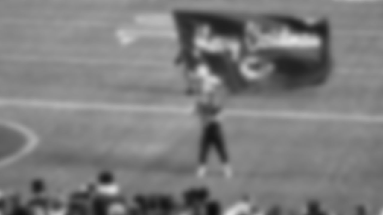 Flag runner wishes the crowd a Merry Christmas during an NFL week 17 matchup against the Denver Broncos, Thursday, December 25, 2025.