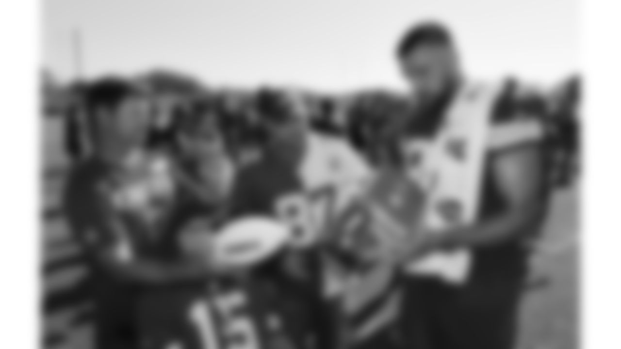 Kansas City Chiefs tight end Travis Kelce (87) signs merchandise of U.S. service members attending Military Appreciation Day during day 17 of Training Camp practice on Wednesday, August 13, 2025.
