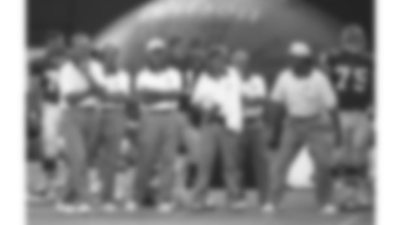 The Kansas City Chiefs coaching staff stands on the sideline during the 1994 preseason game in Tokyo, Japan against the Minnesota Vikings.