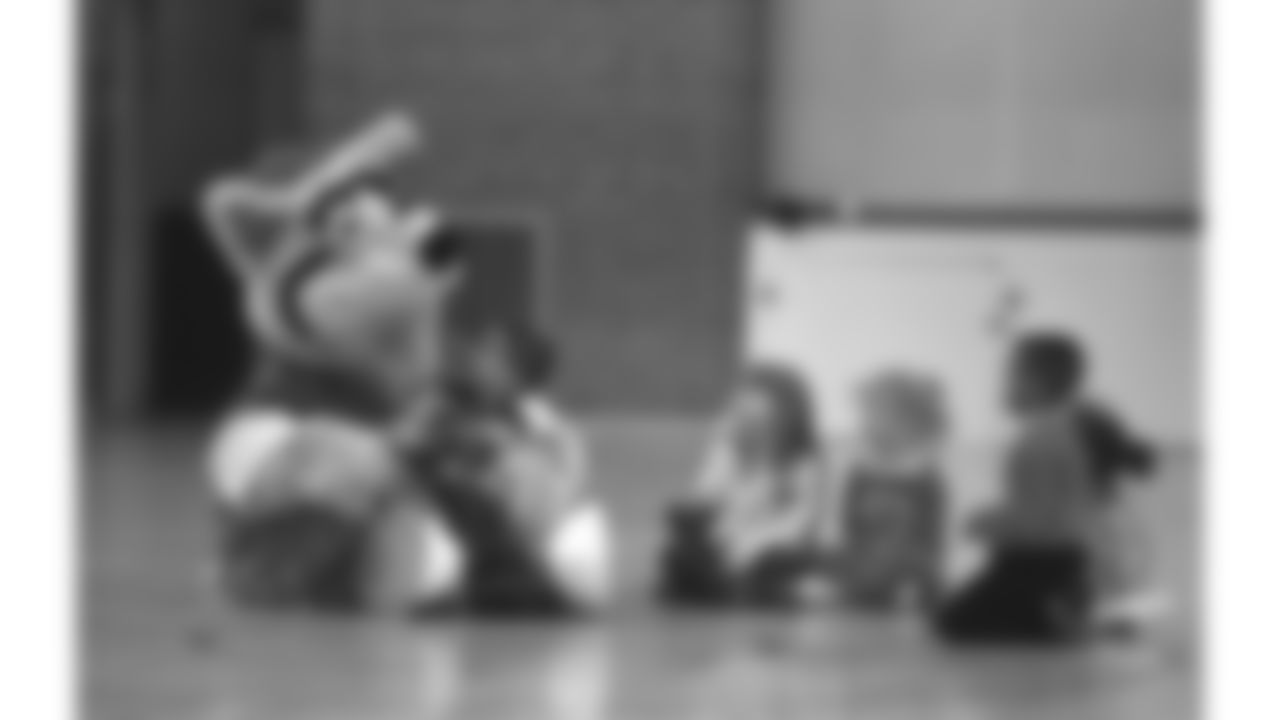KC Wolf hangs out with young students at a 1995 community relations event.