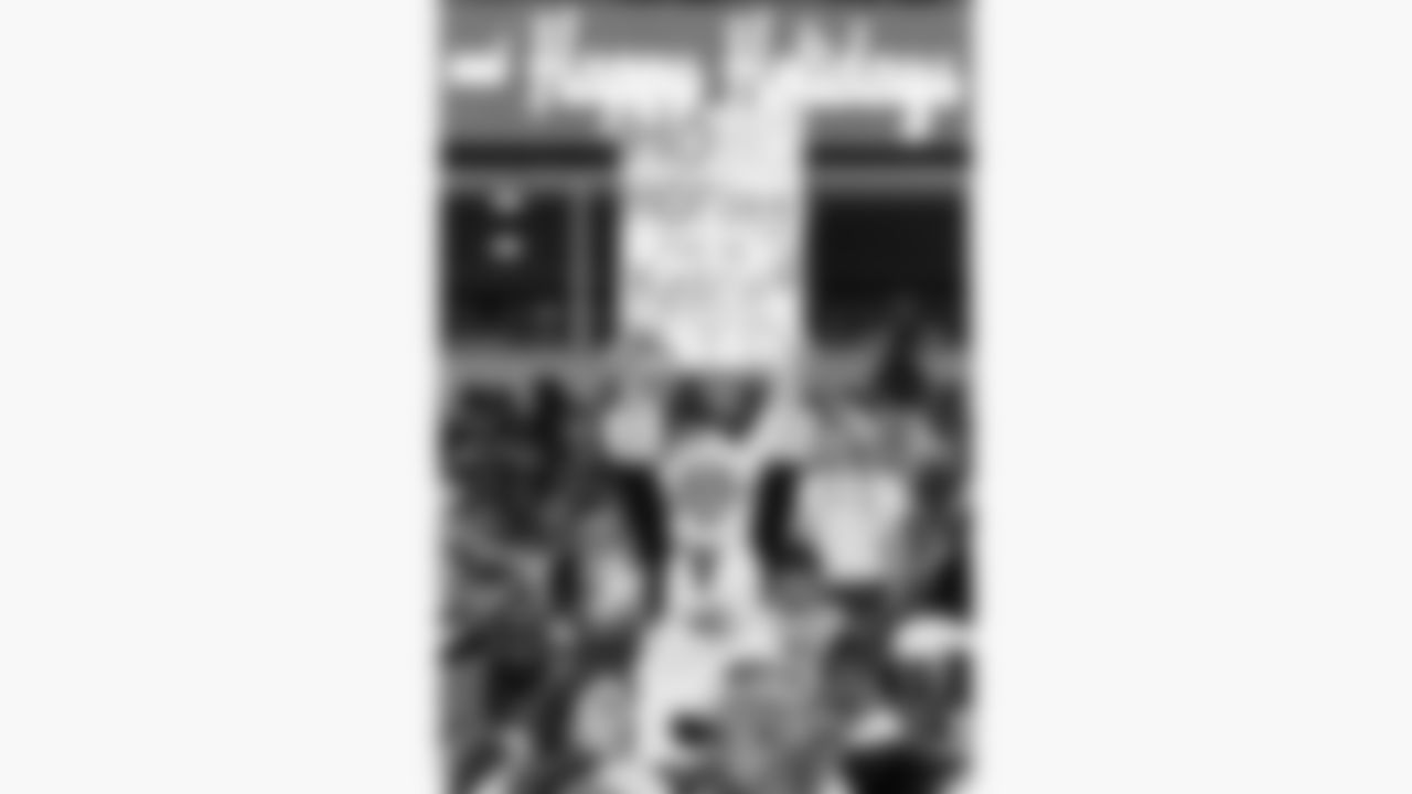 A Kansas City Chiefs fan dressed as Mrs. Claus holds up a sign during a week 17 NFL football game against the Denver Broncos, Thursday, December 25, 2025 in Kansas City, MO.