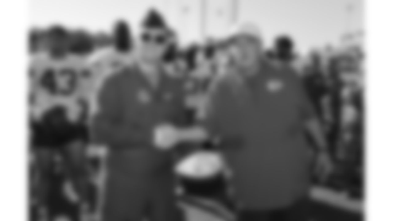 U.S. service members receives a ball from Kansas City Chiefs Head Coach Andy Reid while attending Military Appreciation Day during day 17 of Training Camp practice on Wednesday, August 13, 2025.