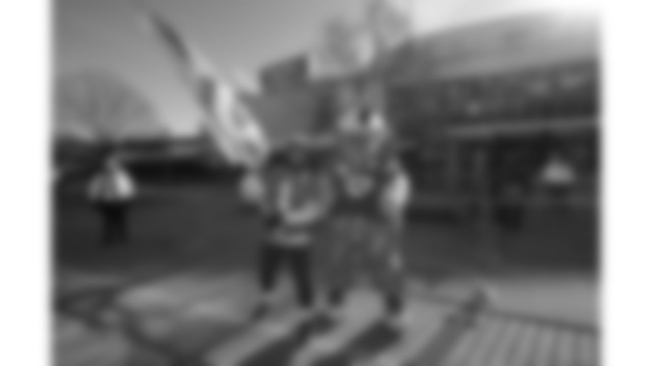 Chiefs Flag Runner and KC Wolf prior to a week 15 NFL Football game against the Los Angeles Chargers on Sunday, December 14, 2025 in Kansas City, MO.