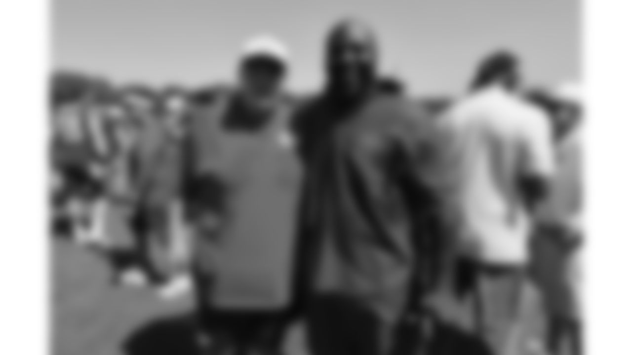 Former Chiefs player Tamba Hali from the Kansas City Ambassadors and Legends group with Head Coach Andy Reid after day 6 of training camp practice on Monday, July 28, 2025.