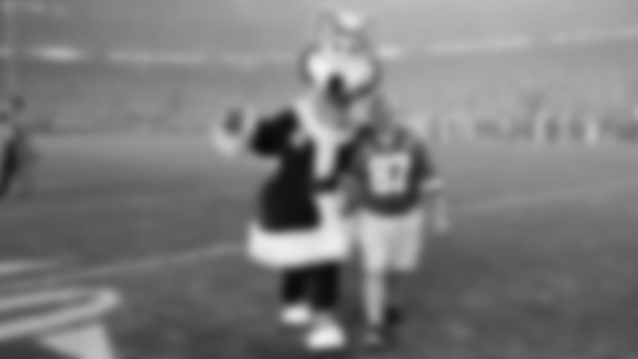 KC Wolf with Coin Toss Captain - Daniel Ezersky prior to an NFL week 17 matchup against the Denver Broncos, Thursday, December 25, 2025.