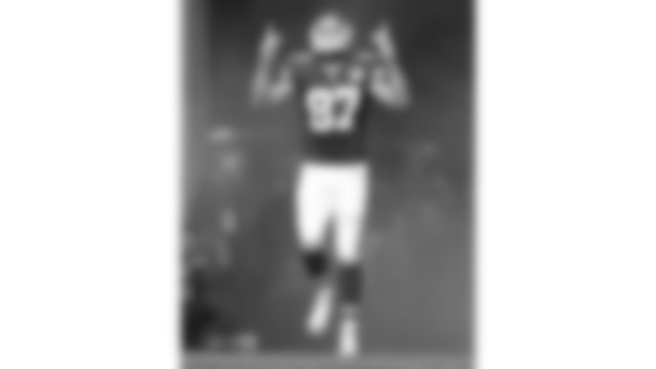 Kansas City Chiefs tight end Travis Kelce (87) points upward as he enters the field for 2015 game against the Detroit Lions at Wembley Stadium in London.