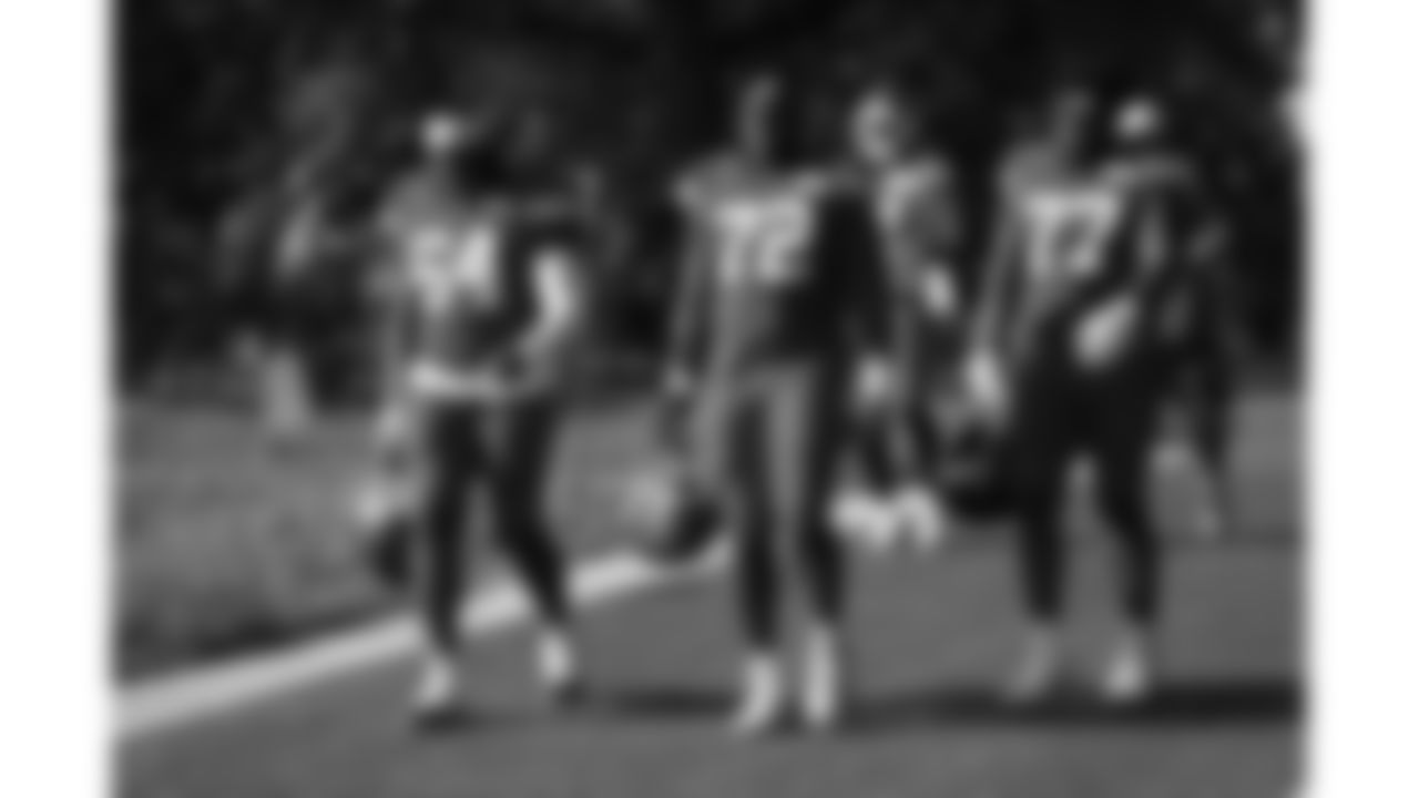 Kansas City Chiefs offensive tackle Wanya Morris (64), tackle Chukwuebuka Godrick (72) and offensive lineman Jaylon Moore (77) arrive at day 6 of training camp practice on Monday, July 28, 2025.
