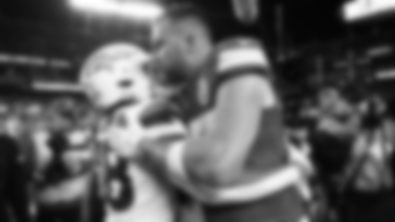 Kansas City Chiefs tight end Travis Kelce (87) talks with Denver Broncos running back Jaleel McLaughlin (38) after an NFL week 17 matchup against the Denver Broncos, Thursday, December 25, 2025.