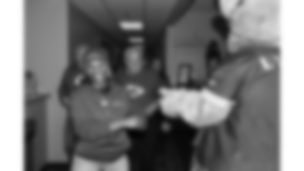 Red Coaters greet KC Wolf as they arrive at the annual Souper Bowl at the Harvesters Community Food Network in Kansas City on Tuesday, February 4, 2026.